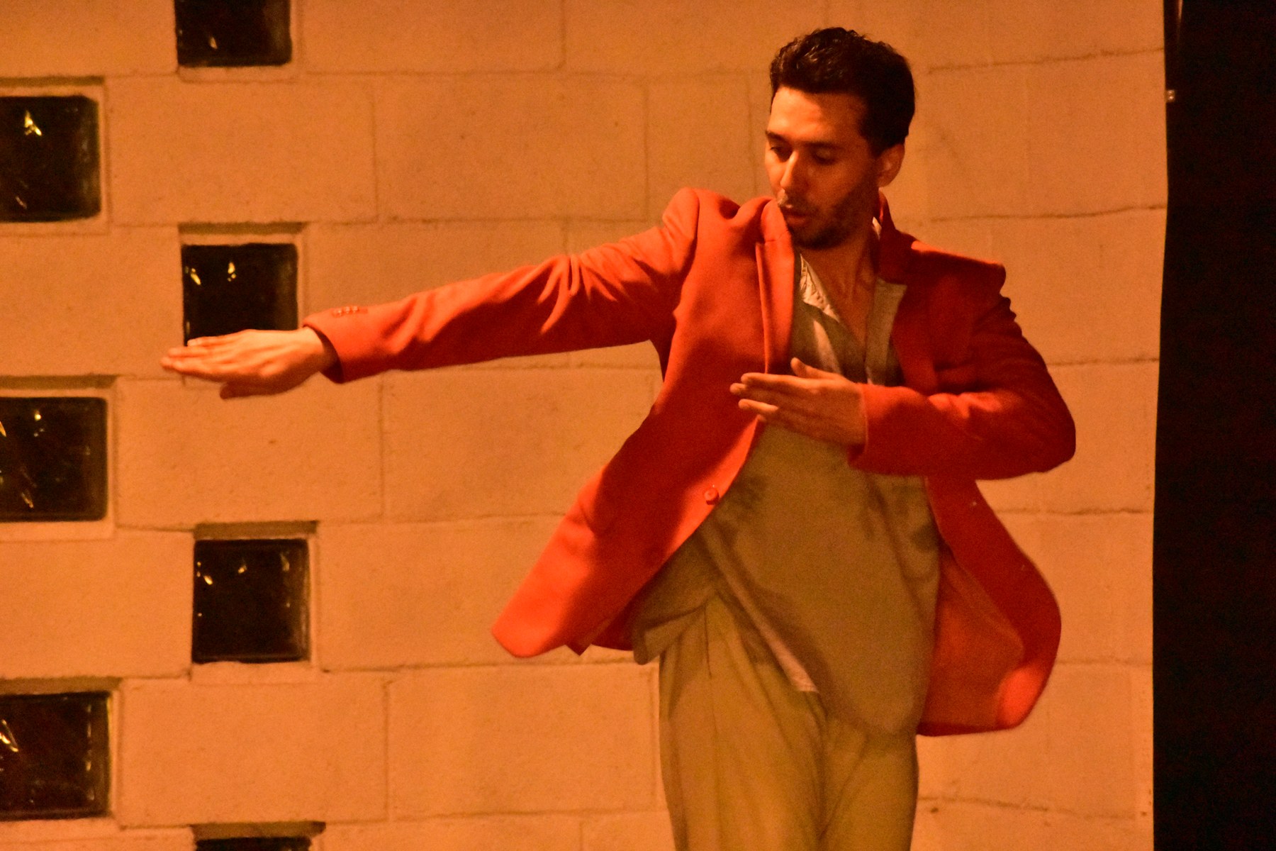 Abhay Mahajan dancing in an orange jacket